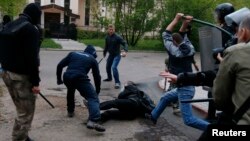 Pro-Russian militants attack a pro-Ukranian protester during a pro-Ukraine rally in the eastern city of Donetsk on April 28.
