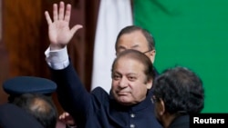 Pakistani Prime Minister Nawaz Sharif waves to the crowd after attending a flag raising ceremony to mark the 66th anniversary of the country's independence on August 14.