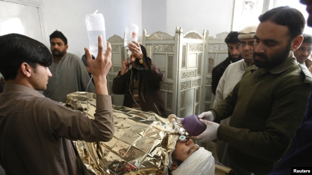 An antipolio campaign worker, Hilal Khan, who was shot and badly injured by unidentified gunmen, receives treatment at Lady Reading Hospital in Peshawar on December 19.