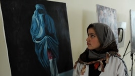 A visitor attends an exhibition in Herat to mark International Women's Day.