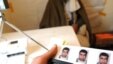 Afghanistan -- A photographer prepares a photograph of a man for identification purposes at an election registration center in Kabul, 02Mar2009