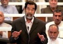 Hussein addressing the court on the first day of his trial, 19 October (AFP)