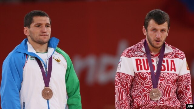 Uzbekistan's Soslan Tigiev (left) with Russia's Denis Tsargush on the podium at the London 2012 Olympic Games in August.