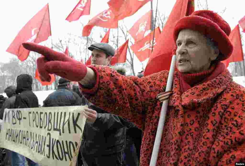 Supporters of the Communist Party hold a rally protesting the arrival of a mission from the International Monetary Fund in Ukraine. The IMF is expected to hold talks with Kyiv on a $15 billion loan. The banner reads "IMF -- A Mortician Of The National Economics." (Reuters/Alexandr Kosarev)