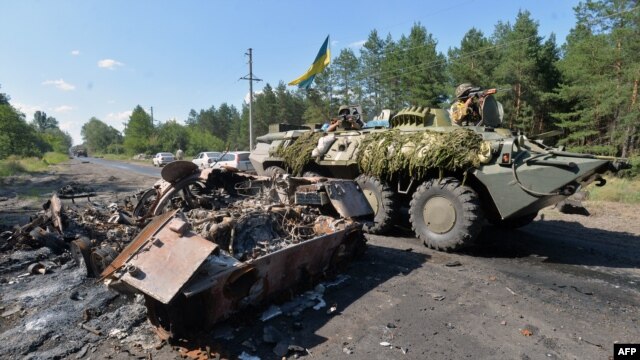 Ukrainian troops drive an armored personnel carrier in Mykolayivka, a small eastern Ukrainian city near Slovyansk, on July 5.