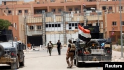 Iraqi security forces gather in center of Fallujah on June 20.