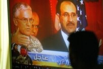 An Iraqi watching the televised press conference at which the killing of al-Zarqawi was announced on June 8 (AFP)