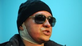 Sergei Filin speaks to journalists as he leaves a Moscow hospital on February 4.