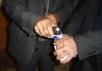 An election monitor inks a voter's hand with invisible ink during the 6 November poll (RFE/RL)