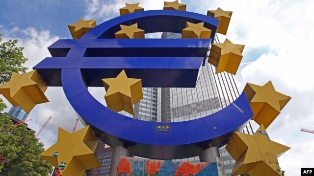 A giant logo of the euro currency stands in front of the European Central Bank in the banking district of Frankfurt, Germany.