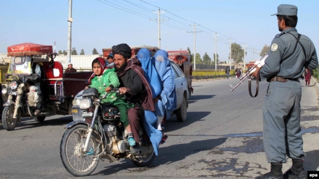 Afghan security officials check people at a road side as part of increased security measures in Helmand Province following the death of Islamic State recruiter Mullah Abdul Rauf in a military operation on February 9.
