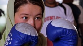 A female boxer takes part in a practice session in preparation for the London 2012 Olympics at a gym in Kabul.