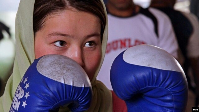 A female boxer takes part in a practice session in preparation for the London 2012 Olympics at a gym in Kabul.