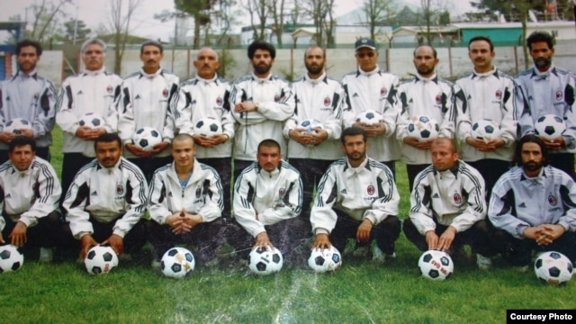 Mohammad Isaq (top right) poses with members of the Sabawoon 1999 soccer team at Ghazi Stadium in Kabul.