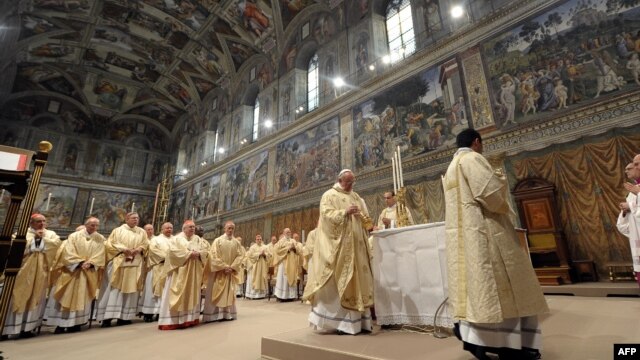Vatican -- This handout picture released by the Press office shows Pope Francis (c), Argentina's Jorge Mario Bergoglio, leading a mass at the Sistine Chapel a day after his election, 14Mar2013