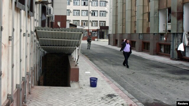 Blood stains the sidewalk in front of the parliament building in Grozny on October 19.