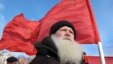 Russia -- A demonstrator with a red Soviet flag stands during a protest rally in Barnaul city in Altai region, 24Mar2010