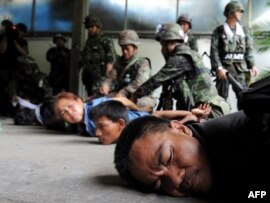 Antigovernment protesters are detained by soldiers inside their camp in Bangkok on May 19.