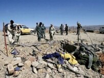 Afghan police inspect the site in Jalalabad where U.S. troops and police clashed (AFP)