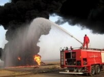 Firefighters cope with an oil-well fire caused by an insurgent bomb outside Kirkuk in late May (epa)