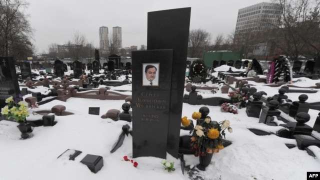 Snow covers the grave of lawyer Sergei Magnitsky with his portrait on the tomb at the Preobrazhenskoye cemetery in Moscow in December.