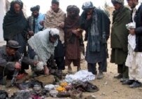 Relatives search through belongings after a suicide bombing in Kandahar Province on 17 January (epa)
