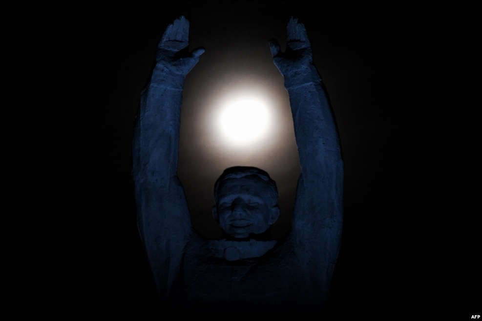 The moon is pictured over a statue of Russian cosmonaut Yury Gagarin at the Russian-leased Baikonur cosmodrome in Kazakhstan. (AFP/Kirill Kudryavtsev)