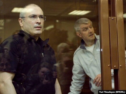 Mikhail Khodorkovsky (left) and co-defendant Platon Lebedev stand behind a glass wall in court in Moscow in May 2011.