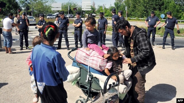 People from a Romany community are expelled by police from their camp in Villeurbanne, outside Lyon, earlier this month.