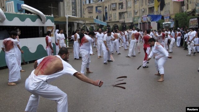 Shi'ite Muslims perform ritual acts of self-flagellation with knives and chains during a religious procession in the Iraqi city of Karbala on November 23.