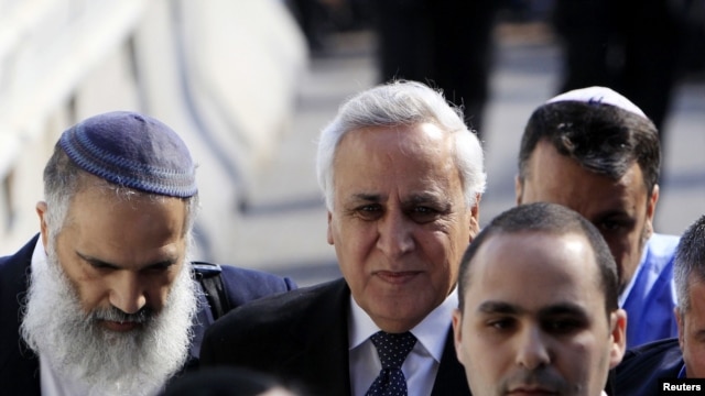 Former Israeli President Moshe Katsav (center) is surrounded by lawyers and relatives as he arrives at a district court for his sentencing in March.