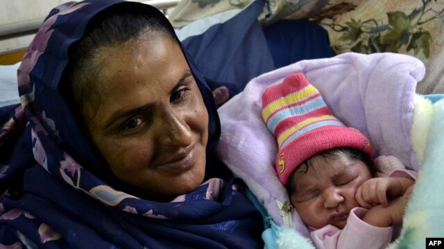Mukhtar Mai shows off her newborn baby boy at a hospital in Multan in November 2011.