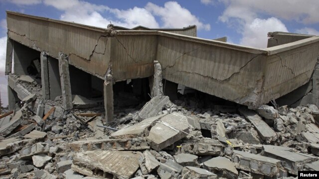 A house lies in rubble after a NATO airstrike near the village of Shal Ghouda in western Libya on August 11.