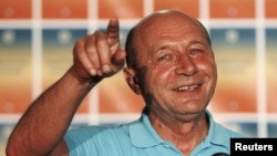 Romanian President Traian Basescu addresses the media after the referendum for his impeachment in Bucharest early on July 30.