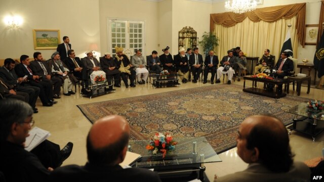 Pakistani Prime Minister Raja Pervez Ashraf (top right) talks with Afghan parliament members during a meeting in Islamabad on December 11.