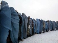 Afghan widows stand in line for international aid on December 22 (epa)
