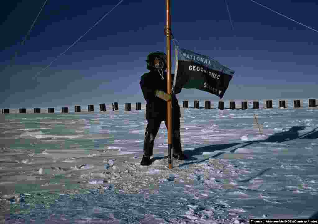 "National Geographic" magazine’s Thomas Abercrombie, the first correspondent to reach the South Pole, in 1957, flies the society’s flag from the pole while reporting on the International Geophysical Year of 1957-58.