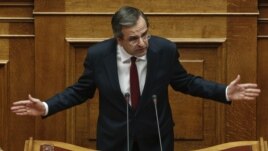 Prime Minister Antonis Samaras addresses parliamentarians before a voting for the 2013 budget in Athens on November 11.