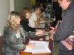 Election workers check voter-registration lists at a polling station in Donetsk