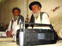 Afghan men at a tea house in the southern Kandahar Province listening to news of the \