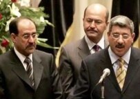 Prime Minister Nuri al-Maliki (left) with Deputy Prime Ministers Barham Salih (center) and Salam al-Zawba'i present the cabinet on May 20 (AFP)