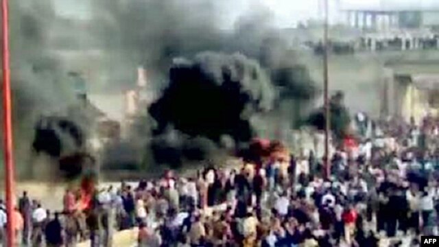 Thick smoke rises as antigovernment protesters demonstrate in Moaret Al-Noman, Syria, in late April.