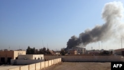 Smoke billows after a government building during fighting between Iraqi forces and IS militants in Ramadi on March 11.