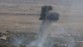 Smoke rises after an explosion in the Syrian village of Bariqa close to the cease-fire line between Israel and Syria.