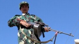 An Afghan National Army soldier stands guard at the Pakistan-Afghanistan border