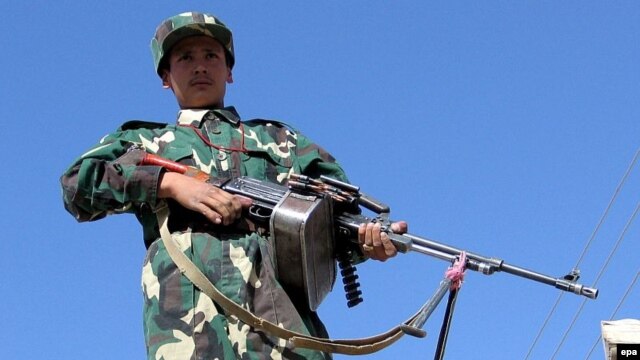 An Afghan National Army soldier stands guard at the Pakistan-Afghanistan border