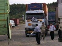 Iranian trucks must unload their cargoes at the border, for Iraqi trucks to take over (AFP)