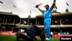 A cricket fan pays homage to a wax figure of Sachin Tendulkar at the Sydney Cricket Ground earlier this year.