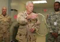 A U.S. military doctor at Guantanamo shows reporters how a feeding tube is used to feed hunger-striking prisoners (file photo) (epa)
