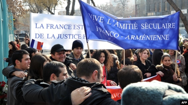 Armenians rally outside the French Embassy in Yerevan to thank France for a bill passed by its Senate making denial of the Armenian genocide a crime on January 24.